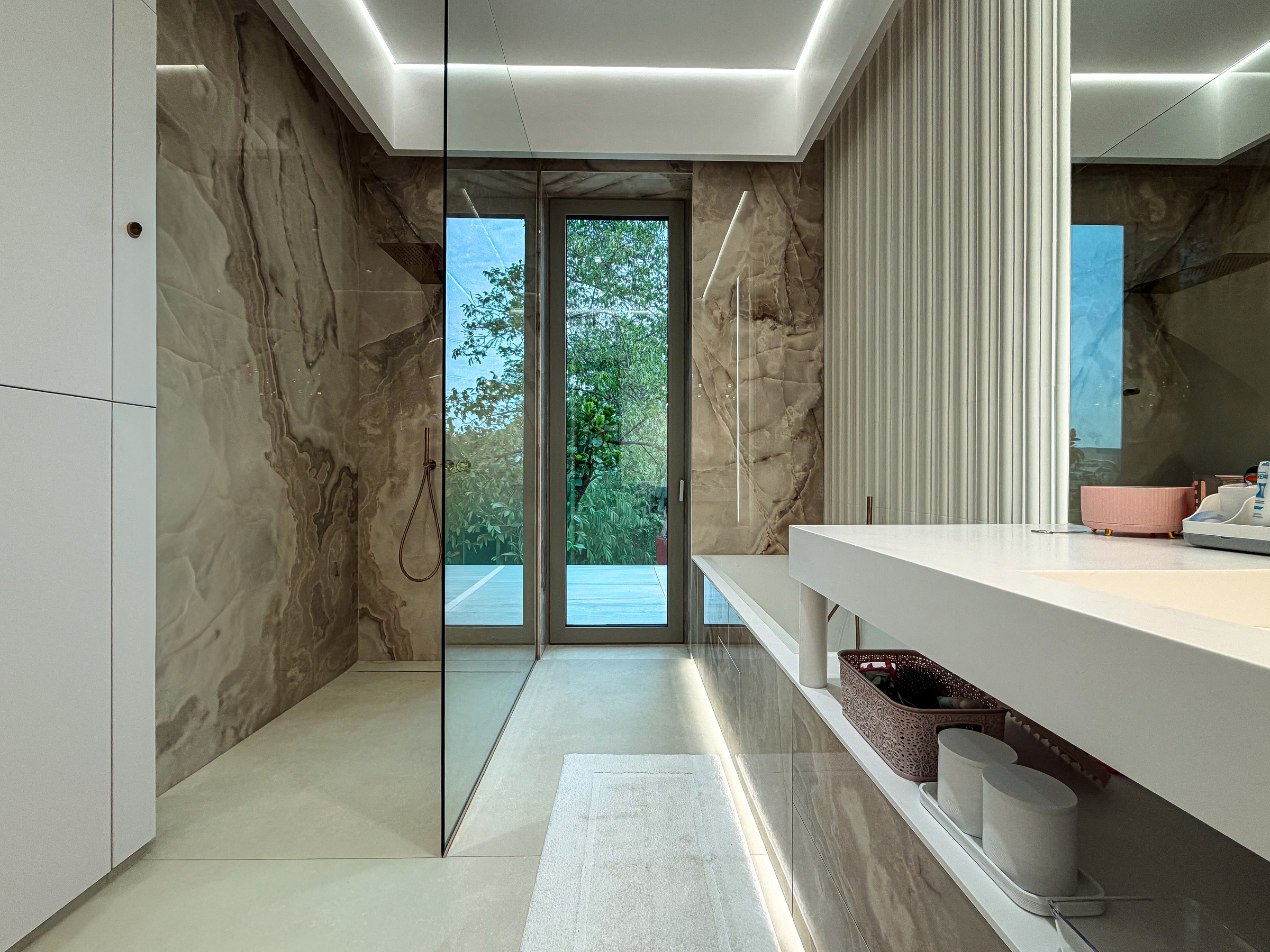 Residential House Cluj — Warm cream stone bathroom