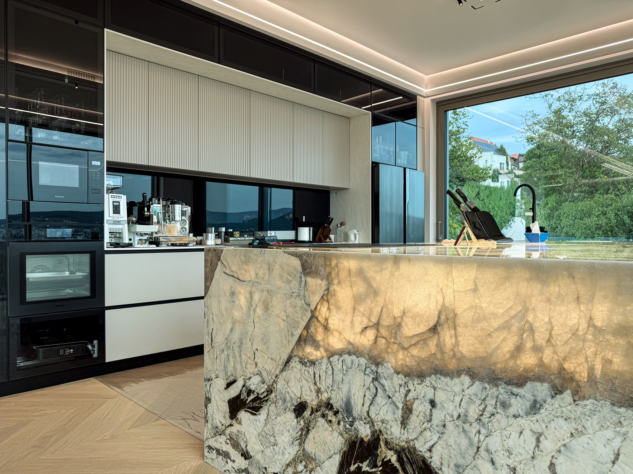 Residential House Cluj — Illuminated Patagonia natural stone kitchen island